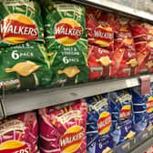 Packets of Walkers crisps on shelves in a supermarket (Shutterstock)
