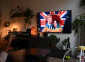 A woman watches an episode of the newly released Netflix docuseries "Harry and Meghan" about Britain's Prince Harry, Duke of Sussex, and Britain's Meghan, Duchess of Sussex, in London. Picture: Daniel Leal/AFP via Getty Images