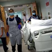 Medical staff transfer a patient along a corridor at the Royal Blackburn Teaching Hospital (Photo: HANNAH MCKAY/POOL/AFP via Getty Images)