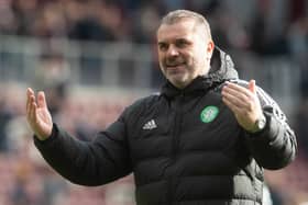 Ange Postecoglou celebrates with the Celtic fans after the victory over Hearts.
