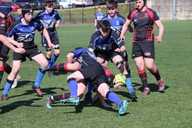 Biggar players (wearing red) in action against hosts Dalziel in the under-16 tournament (Pic courtesy of Dalziel Rugby Club)