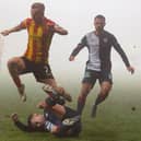 Partick Thistle's Scott Tiffoney is tackled by Dylan Tait last Saturday (Pic: Euan Cherry/SNS Group)