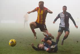 Partick Thistle's Scott Tiffoney is tackled by Dylan Tait last Saturday (Pic: Euan Cherry/SNS Group)