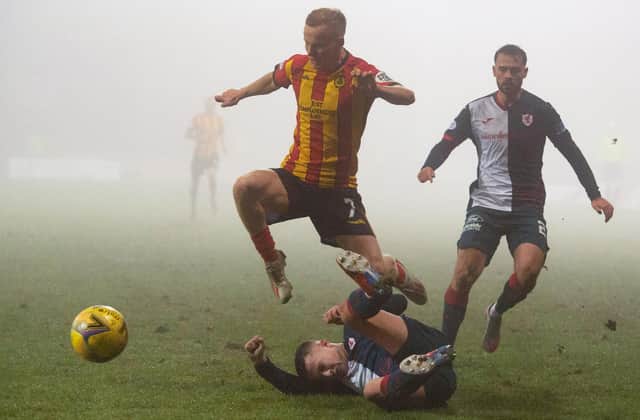 Partick Thistle's Scott Tiffoney is tackled by Dylan Tait last Saturday (Pic: Euan Cherry/SNS Group)