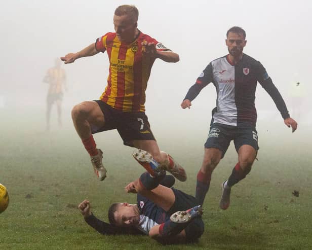 Partick Thistle's Scott Tiffoney is tackled by Dylan Tait last Saturday (Pic: Euan Cherry/SNS Group)