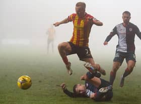 Partick Thistle's Scott Tiffoney is tackled by Dylan Tait last Saturday (Pic: Euan Cherry/SNS Group)