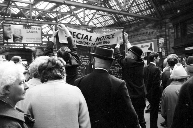 Notice of cancelled trains being put up at Glasgow Central.