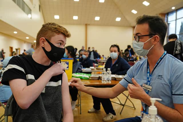 Owen Morrison, 15, receives his Covid-19 vaccine from student nurse Anthony McLaughlin during a vaccination clinic at the Glasgow Central Mosque. Picture: PA