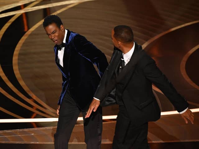 Actor Will Smith appears to slap actor Chris Rock onstage during the 94th Oscars. 