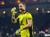 Celtic goalkeeper Joe Hart shows off his winner's medal after the Premier Sports Cup victory over Hibs.