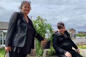 Giorgi Kakava and his gran Ketino Baikhadze at the tree planted in his mum Sopio’s memory