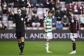 Celtic's Yang Hyun-jun watches referee Don Robertson signal he is going to the VAR monitor. The South Korean winger was subsequently sent off.