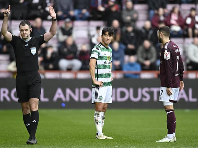 Celtic's Yang Hyun-jun watches referee Don Robertson signal he is going to the VAR monitor. The South Korean winger was subsequently sent off.