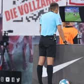 Referee checks VAR screen during a German league match (Pic by Alex Grimm/Getty Images)