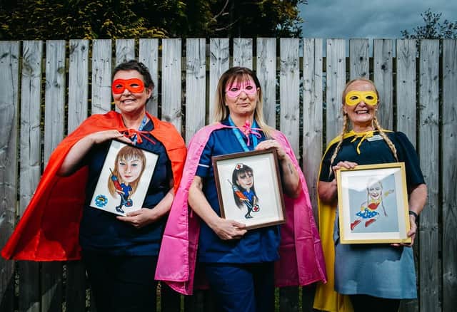 7/5/2021. FREE TO USE PICS. Pics of care home nurse Lynn Bell, who has done cartoon "superhero" paintings of all her colleagues at Parksprings Care Home in Motherwell.Pic shows L-R: Linda Webb, Michelle Carrigan, Rosie Brennan.