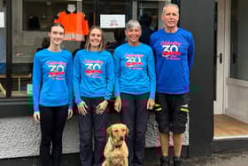 Shop manager Arlene Peat and Holly Tkalcic with Alan and Lesley Snell in front of the shop.