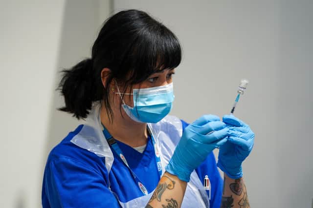 A member of staff prepares a Covid-19 Pfizer jab at a pop-up vaccination centre at Westfield Stratford City shopping centre in east London, where TikTok are encouraging young Londoners to get jabbed. Picture date: Saturday October 2, 2021.