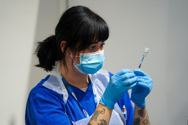 A member of staff prepares a Covid-19 Pfizer jab at a pop-up vaccination centre at Westfield Stratford City shopping centre in east London, where TikTok are encouraging young Londoners to get jabbed. Picture date: Saturday October 2, 2021.