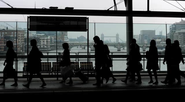 Commuters make their way across the platform at Blackfriars Station, London, in the morning rush hour.