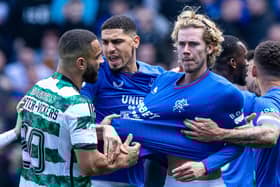 Celtic's Cameron Carter-Vickers grabs Rangers' Todd Cantwell by the shirt at full time.