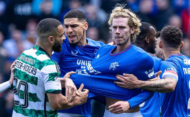 Celtic's Cameron Carter-Vickers grabs Rangers' Todd Cantwell by the shirt at full time.