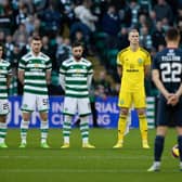 Celtic and Ross County players observe the Remembrance minute's silence that pockets of the home support demonstrated ignorance in disrupting. (Photo by Craig Foy / SNS Group)