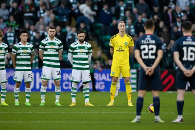 Celtic and Ross County players observe the Remembrance minute's silence that pockets of the home support demonstrated ignorance in disrupting. (Photo by Craig Foy / SNS Group)