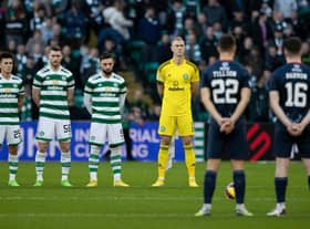 Celtic and Ross County players observe the Remembrance minute's silence that pockets of the home support demonstrated ignorance in disrupting. (Photo by Craig Foy / SNS Group)