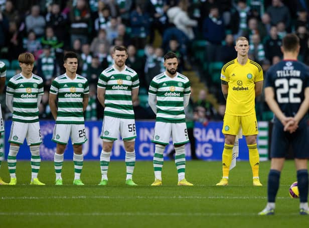 <p>Celtic and Ross County players observe the Remembrance minute's silence that pockets of the home support demonstrated ignorance in disrupting. (Photo by Craig Foy / SNS Group)</p>