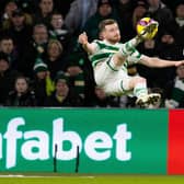 Celtic's Anthony Ralston with an acrobatic attempt on goal as Hearts defender Kye Rowles looks on.