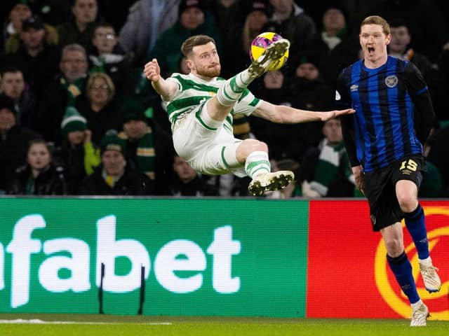 Celtic's Anthony Ralston with an acrobatic attempt on goal as Hearts defender Kye Rowles looks on.