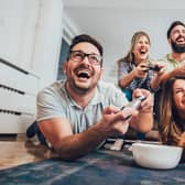 A group of friends playing video games together at home