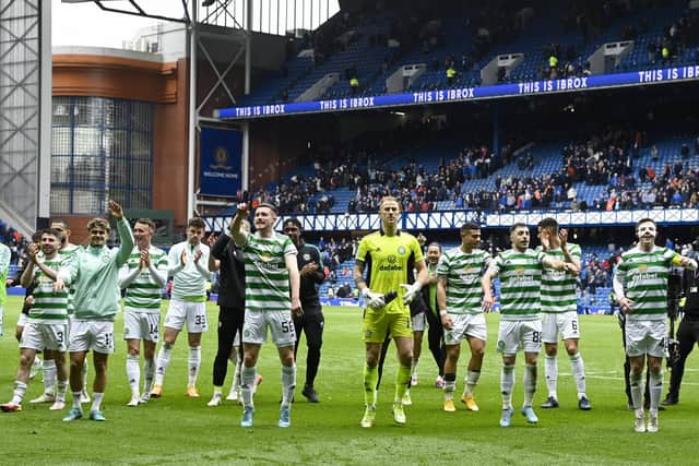 Celtic players celebrate at full time after the 2-1 win at Ibrox.