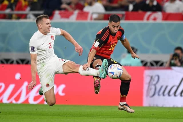 Eden Hazard of Belgium battles for possession with Alistair Johnston of Canada.