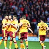 Ricki Lamie is congratulated by his team-mates after scoring winner against Hearts (Pic by Ian McFadyen)