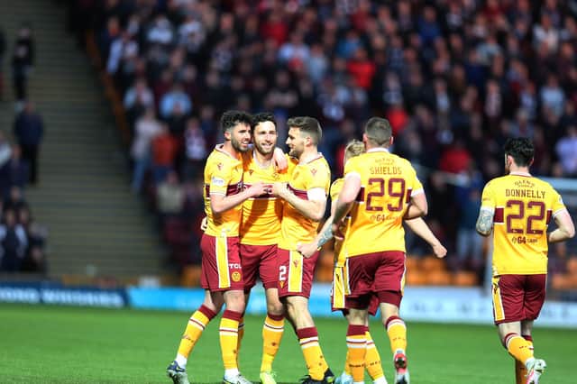 Ricki Lamie is congratulated by his team-mates after scoring winner against Hearts (Pic by Ian McFadyen)