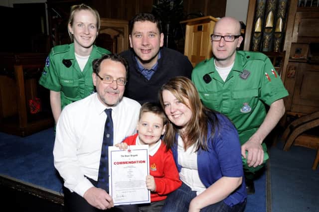 Jamie Martin (6) receives a Commendation certificate from Boys' Brigade Vice-President Alistair Burrow.
1st Condorrat BB.
With mum Elaine (32), dad Tony (36) and from Cumbernauld Ambulance Station Lisa Clark and Eric McManus 
Pic by Alan Murray  28-04-13