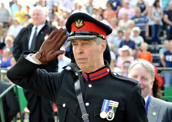Official duty...Deputy Lord Lieutenant of Lanarkshire Colonel David Cranston takes the salute (Pic Lindsay Addison)