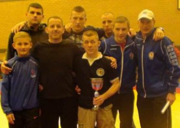 WINNER: Craig McDonald with members of the Tryst Lions Wrestling Club.