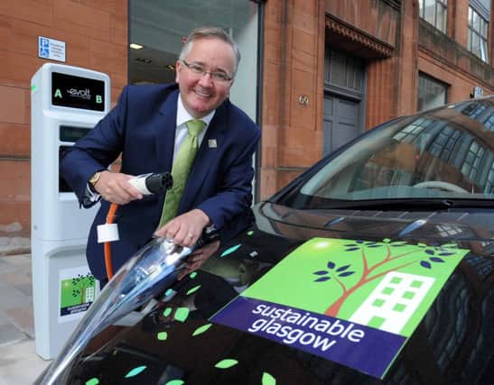 Council leader Gordon Matheson charges a car at one of Sustainable Glasgow's new sites.
