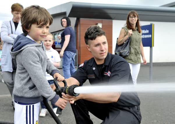Hose about that then...wee one finds out how hard it is being a firefighter at Law Primary School Summer Fayre 2013 (Pic Lindsay Addison)
