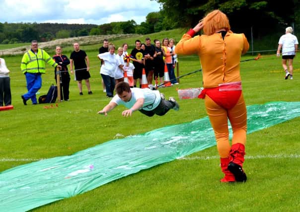 Taking a dive...in the amazing bungee rope competition at the 2013 It's A Knockout event in Douglas (Pic Rodger Price)