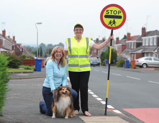 Meadowburn Primary School picture of crossing patroller Alice Abercrombie and Kim McLeod and dog Bracken . Alice been nominated for a Smile Award.
Photo Emma Mitchell
23/8/13