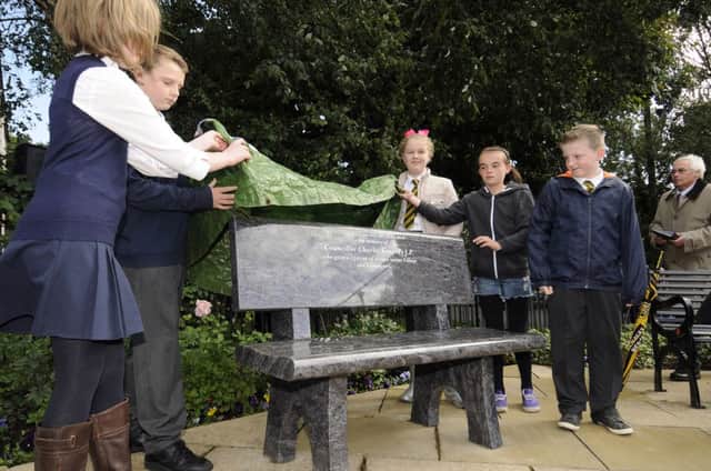 School children unveil the memorial bench