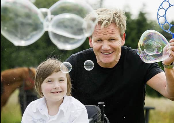 Gordon Ramsay OBE, Honorary Patron of the Scottish Spina Bifida Association, with wee Beau at one of Gordon's many visits to the Charity's family Support Centre.