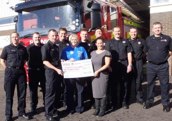 CAR WASH: Cumbernauld firefighters helped raise £300 for the Scottish Spina Bifida Association by holding a charity car wash in Tesco, Cumbernauld.