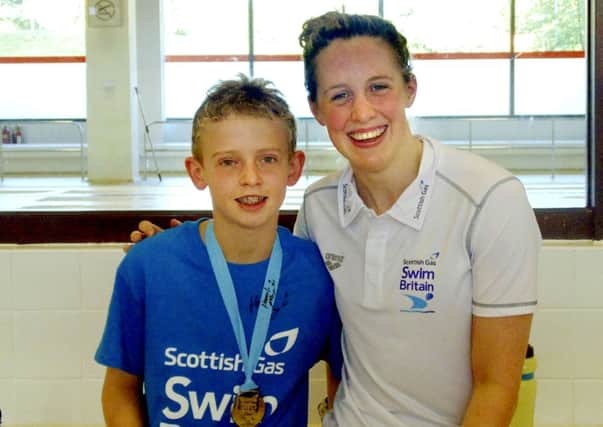 13-year-old Kyle McEwan from Lanark pictured with Commonwealth Games swimmer Hannah Miley. Kyle won competition to swim with Hannah at Commonwealth pool in Edinburgh.