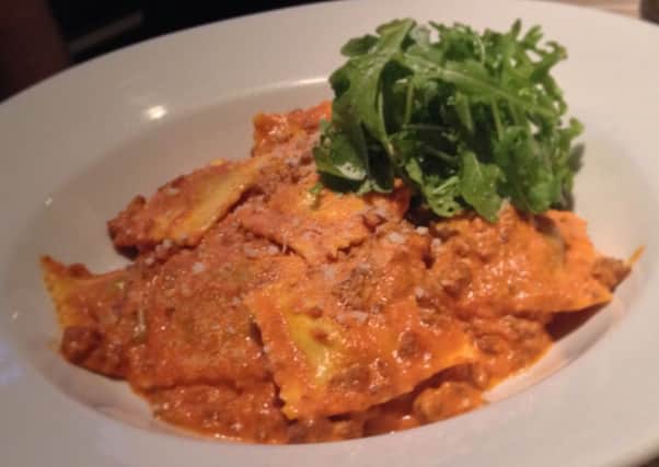 Braised beef ravioli served in a creamy ragu and topped with  rocket leaves