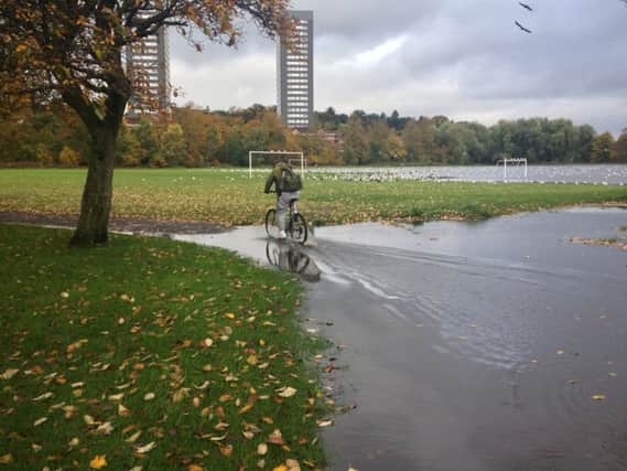 Above: cycling (and football) may prove difficult at the waterlogged King George V Park. Below: Roadworks and flooding at Thornliebank Road caused further chaos on the roads.