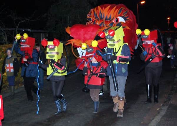 Breathing heat...into Thankerton's bonfire night, a dragon took centre stage at the event